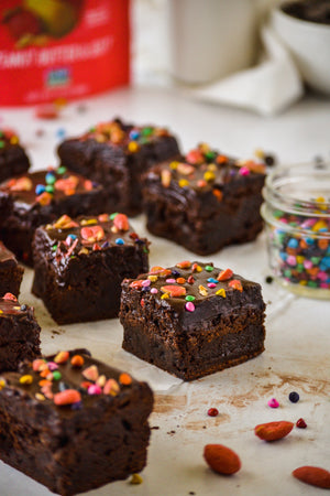 Cosmic Brownies topped with SkinnyDipped Peanut Butter & Jelly Peanuts